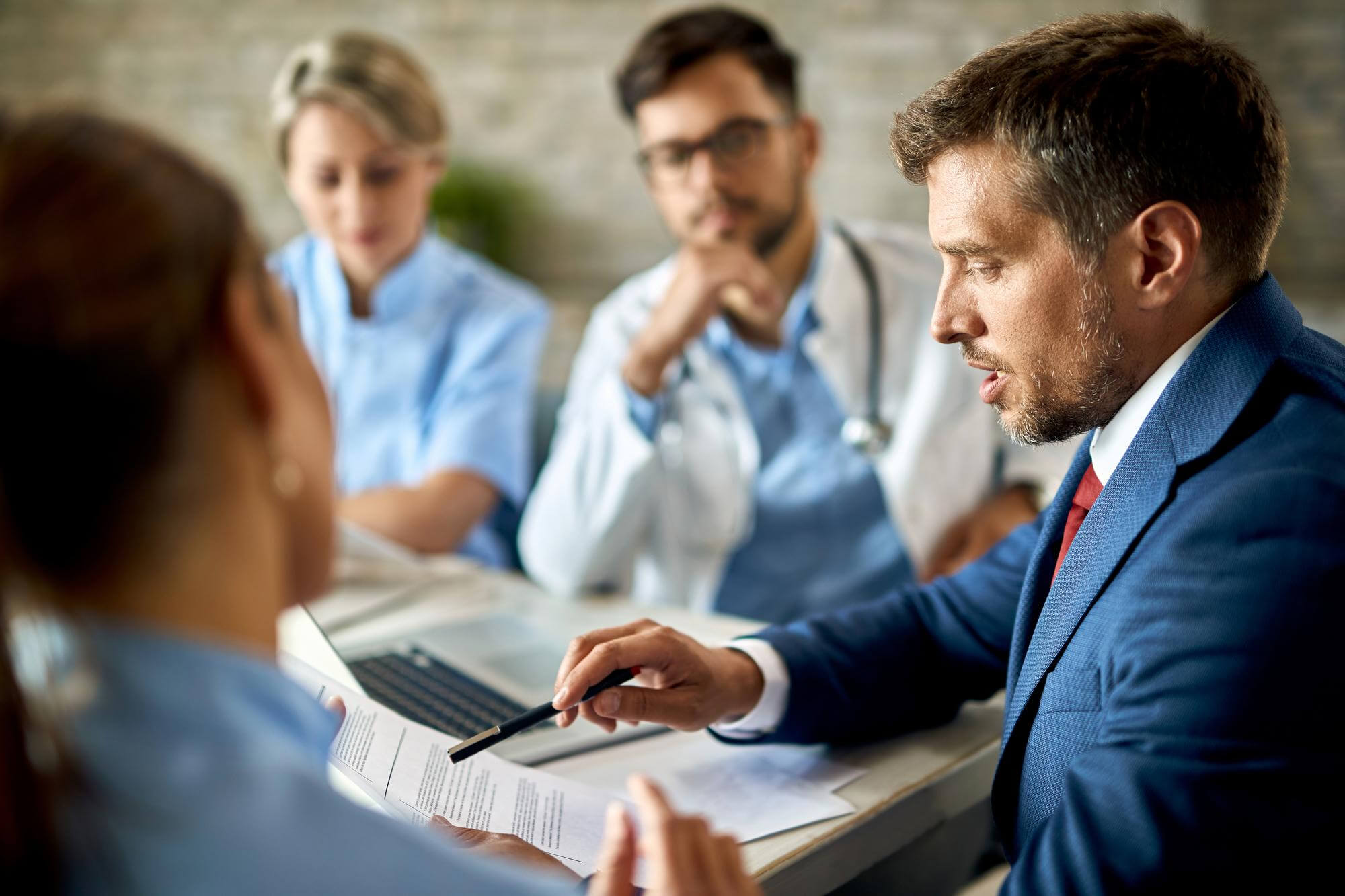 Patient discussing medical care with healthcare professionals