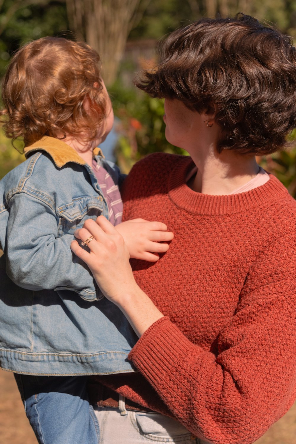 Parent holding a young child outdoors